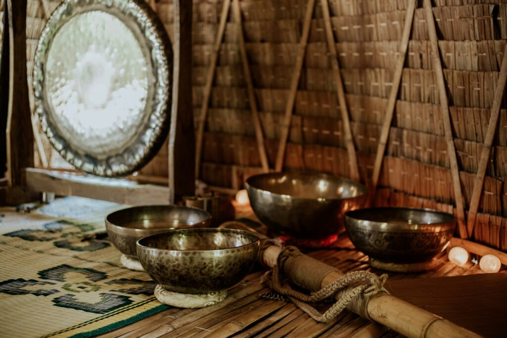 Set of singing bowls and the gong, used in sound healing therapy.